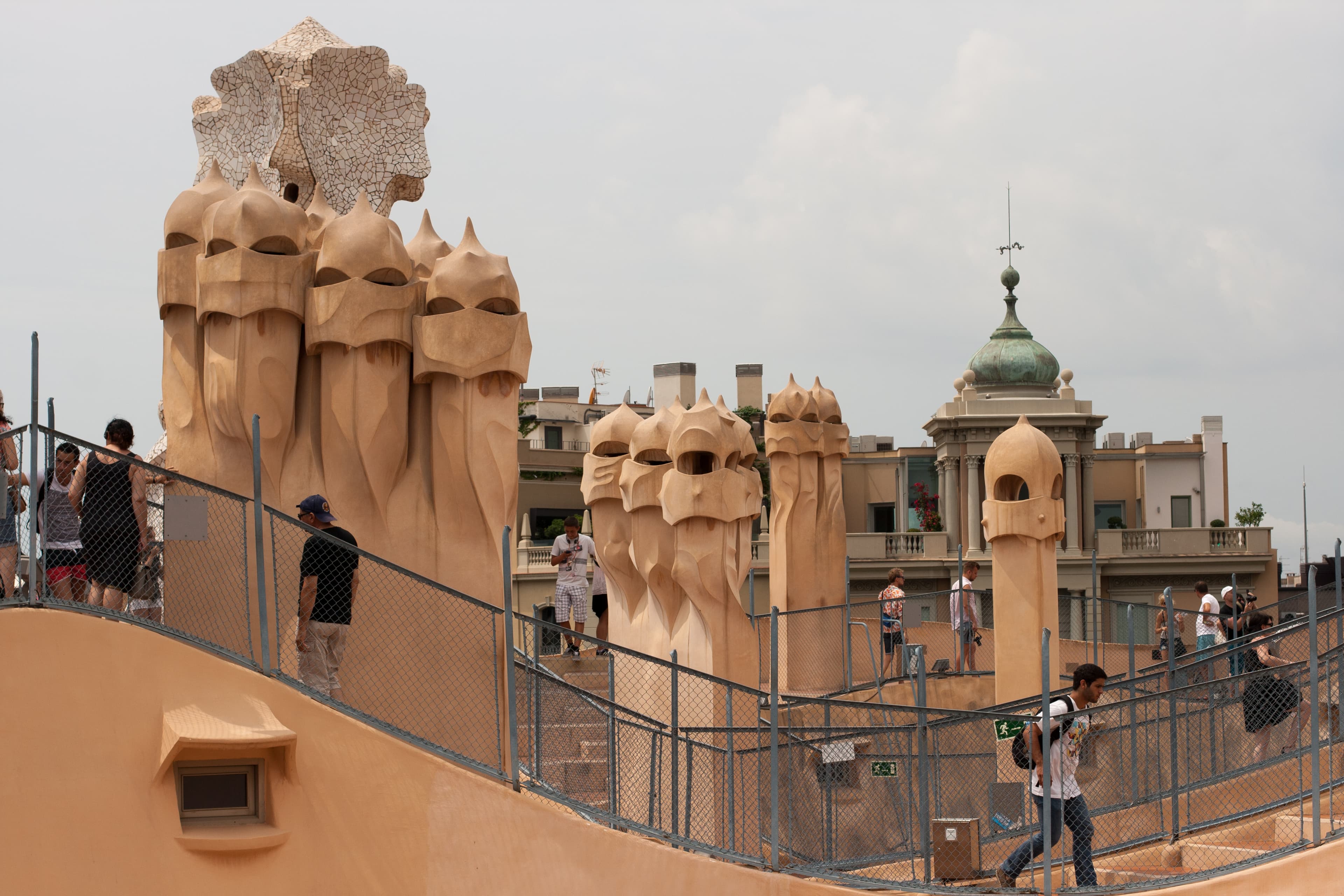 Visitors on the rooftop terrace of Antoni Gaudí's Casa Milà (La Pedrera) on Passeig de Gràcia, the marathon start boulevard, surrounded by the building's distinctive sculpted chimneys, Barcelona
