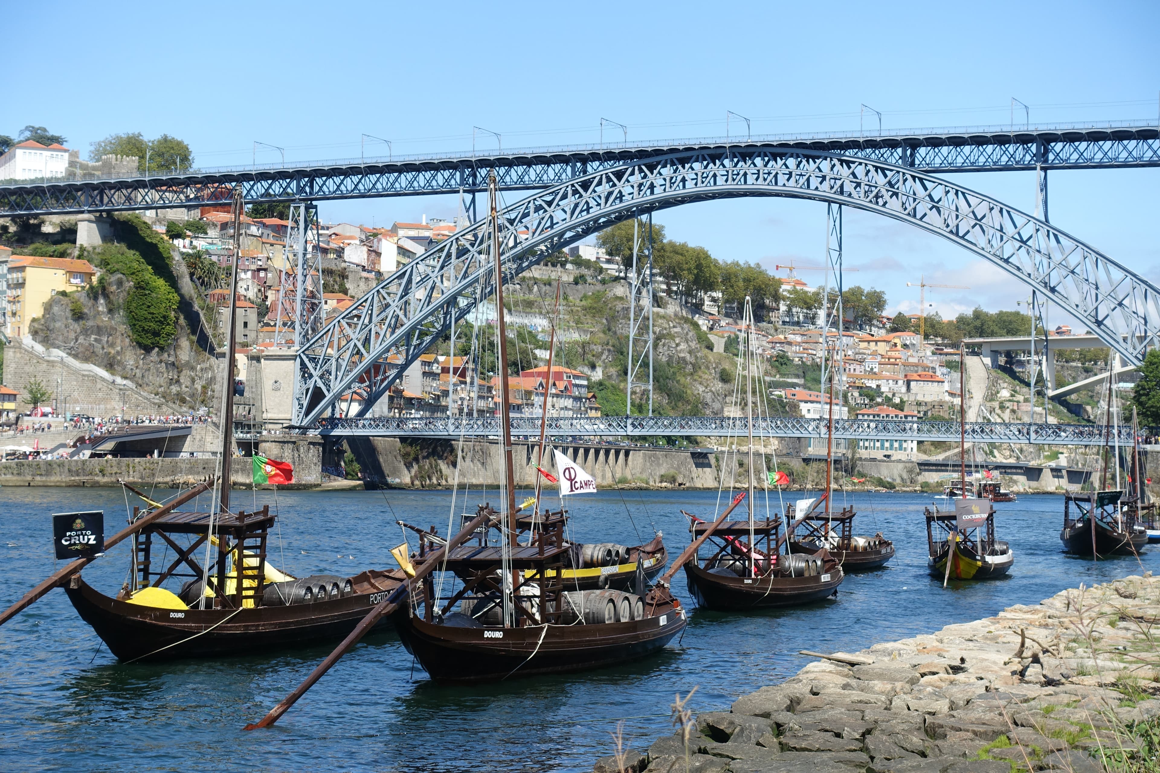 The historic Ribeira waterfront in Porto with the Dom Luís I bridge in the background