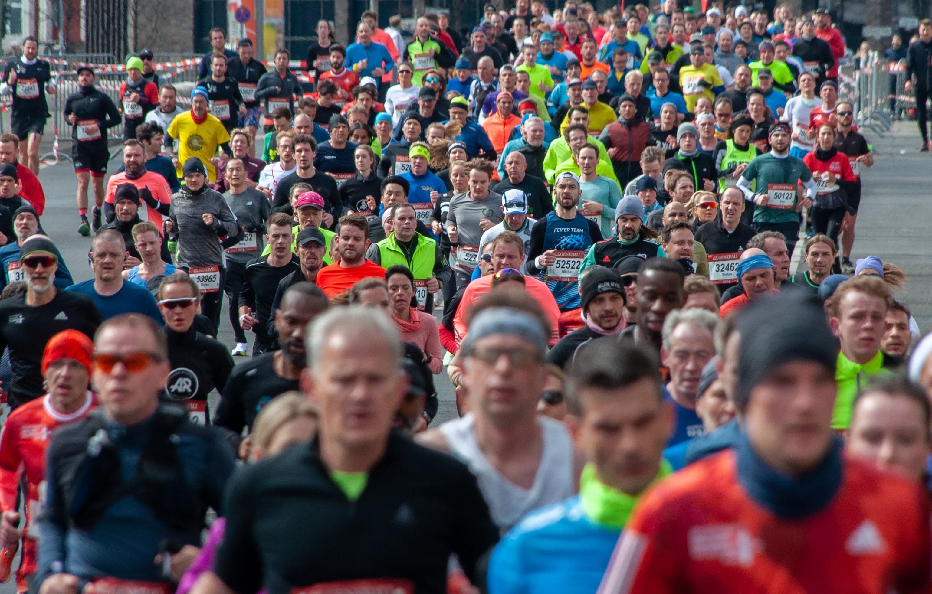 A large diverse field of runners at a mass-participation road marathon, including charity runners and first-timers