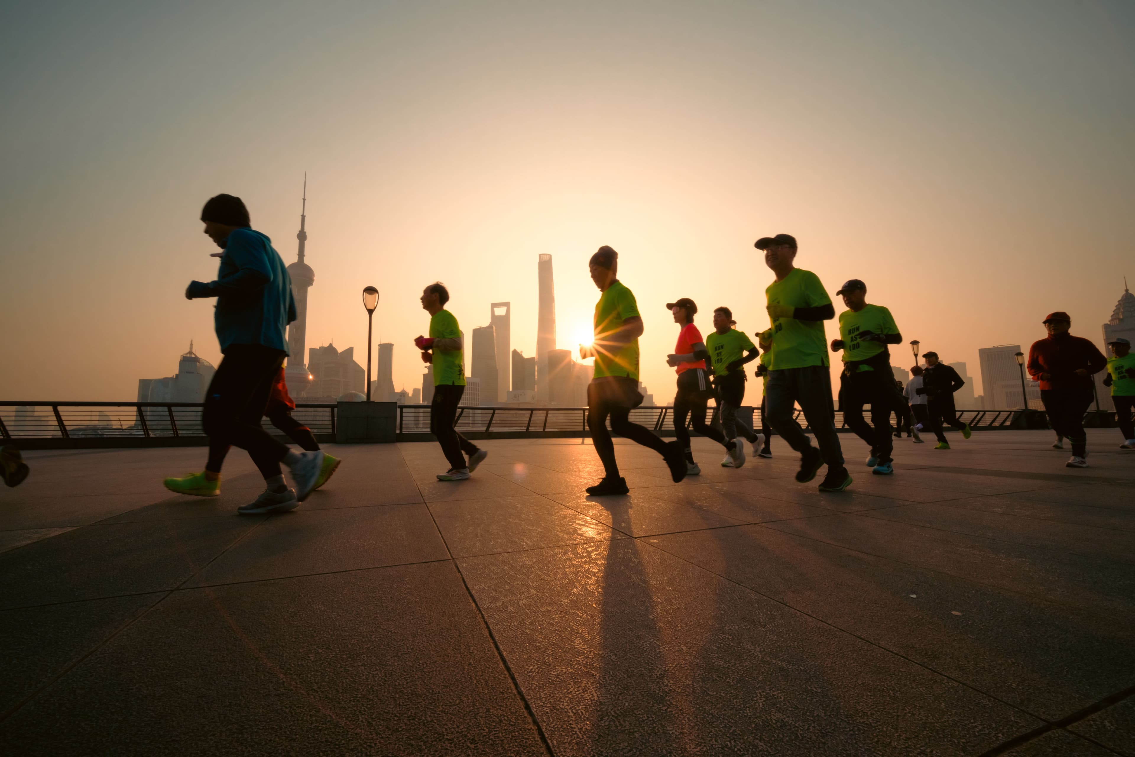 A lone runner on a road in early morning light, representing marathon travel preparation across time zones